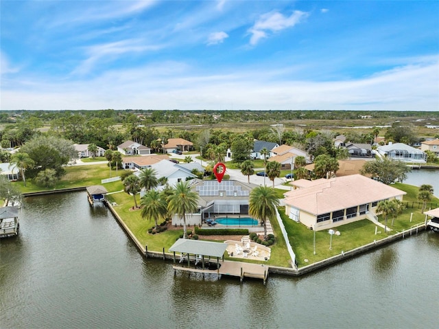 birds eye view of property featuring a water view and a residential view