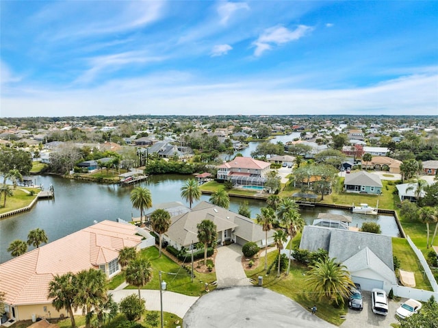 drone / aerial view with a residential view and a water view