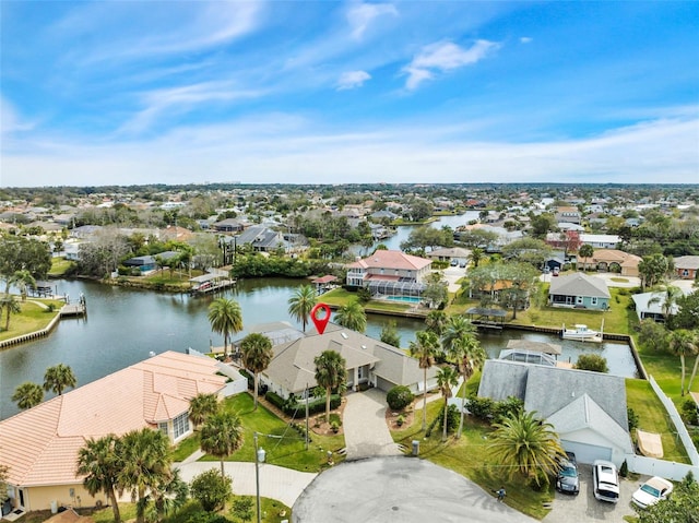 drone / aerial view featuring a water view and a residential view