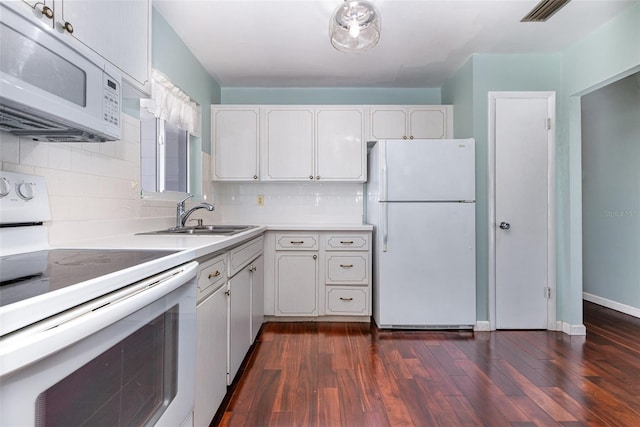 kitchen with white appliances, visible vents, dark wood finished floors, decorative backsplash, and white cabinetry