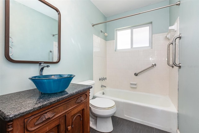 full bathroom with toilet, vanity, and washtub / shower combination