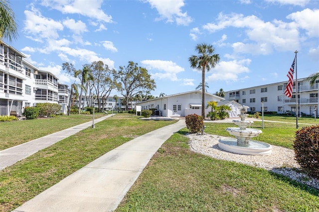 view of property's community with a residential view and a yard