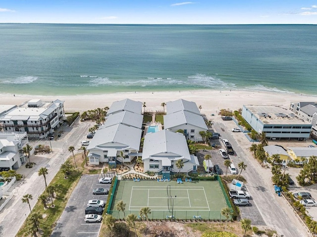 birds eye view of property featuring a beach view and a water view