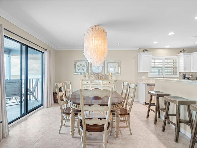 dining space with baseboards, ornamental molding, a chandelier, and recessed lighting