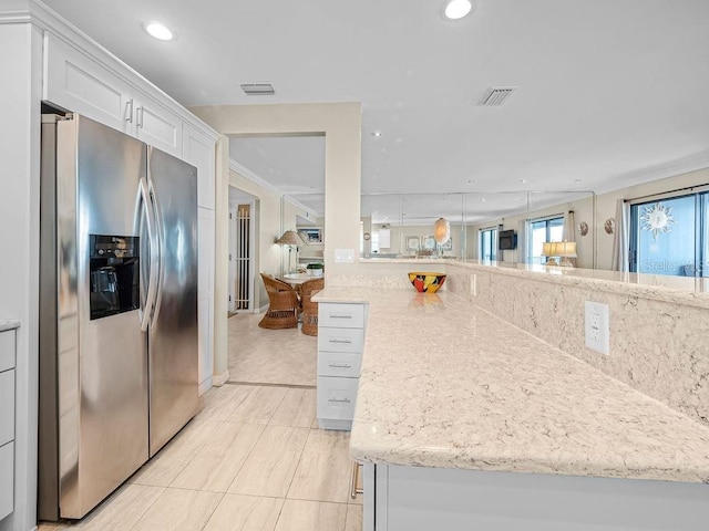 kitchen with visible vents, white cabinets, stainless steel refrigerator with ice dispenser, and recessed lighting