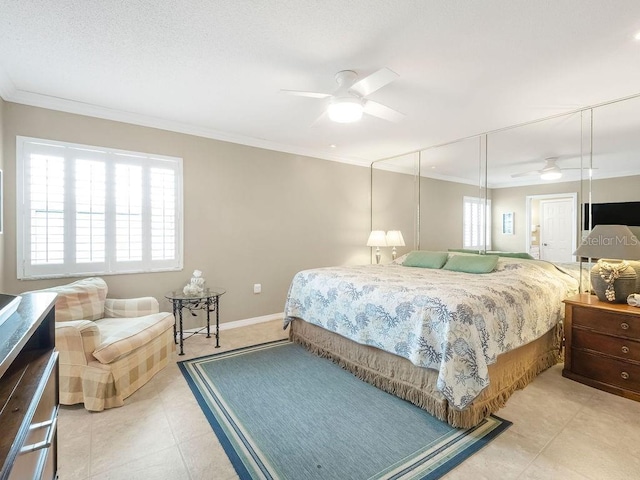 bedroom with light tile patterned floors, a ceiling fan, baseboards, and crown molding