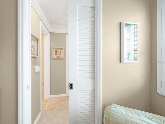 bedroom with light tile patterned floors, crown molding, and baseboards