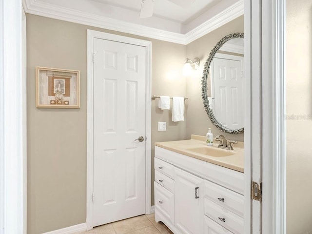 bathroom with vanity, baseboards, crown molding, and tile patterned floors