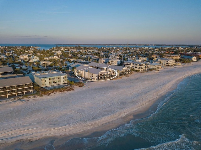 drone / aerial view featuring a water view and a beach view