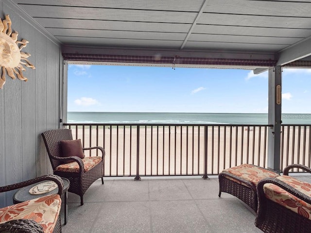 balcony with a water view and a beach view