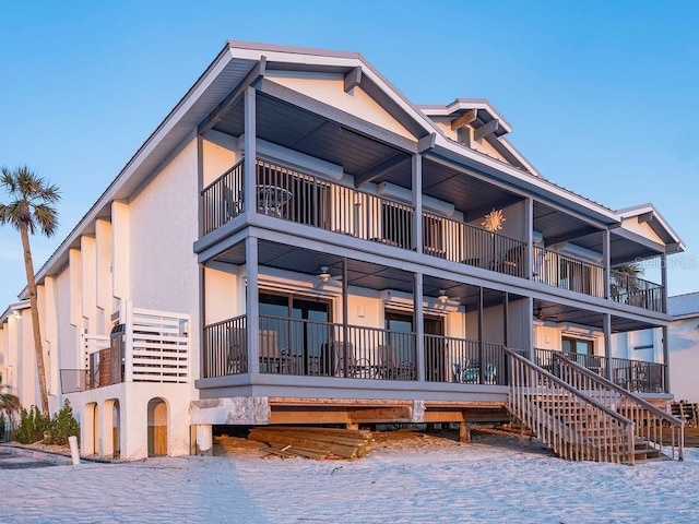 exterior space with stucco siding and stairs