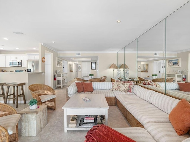 living room featuring visible vents and crown molding