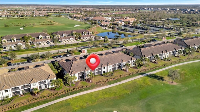 drone / aerial view featuring a water view, a residential view, and golf course view