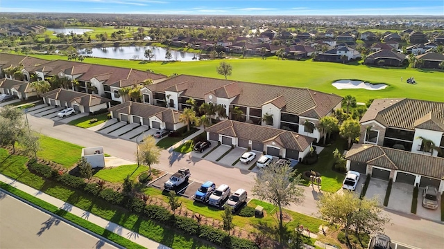 birds eye view of property featuring a water view, view of golf course, and a residential view