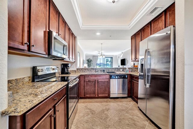 kitchen with stainless steel appliances, a raised ceiling, visible vents, and crown molding