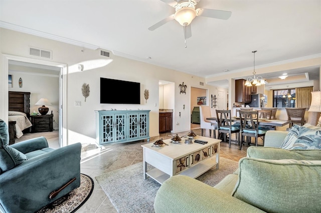 living room with ceiling fan with notable chandelier, ornamental molding, light tile patterned flooring, and visible vents