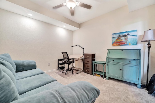 office area with light carpet, ceiling fan, and baseboards