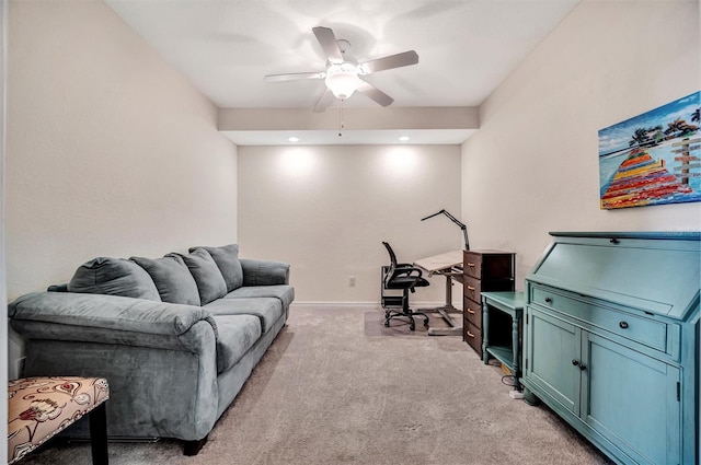 living area featuring baseboards, a ceiling fan, and light colored carpet