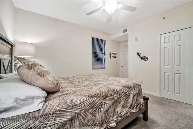 carpeted bedroom featuring a ceiling fan, a closet, visible vents, and baseboards