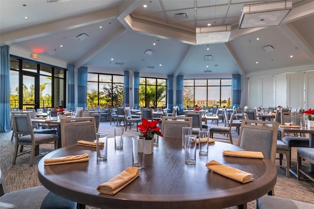 dining space featuring visible vents, high vaulted ceiling, beamed ceiling, and a wealth of natural light