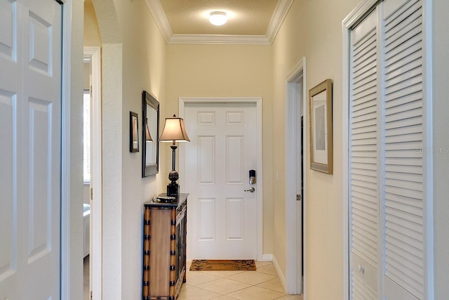 interior space with arched walkways, crown molding, a textured ceiling, and light tile patterned floors