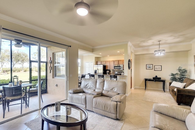 living area with ornamental molding, light tile patterned flooring, ceiling fan, and baseboards