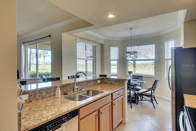 kitchen with light stone countertops, crown molding, appliances with stainless steel finishes, and a sink