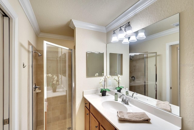 bathroom with crown molding, a shower stall, a textured ceiling, and vanity