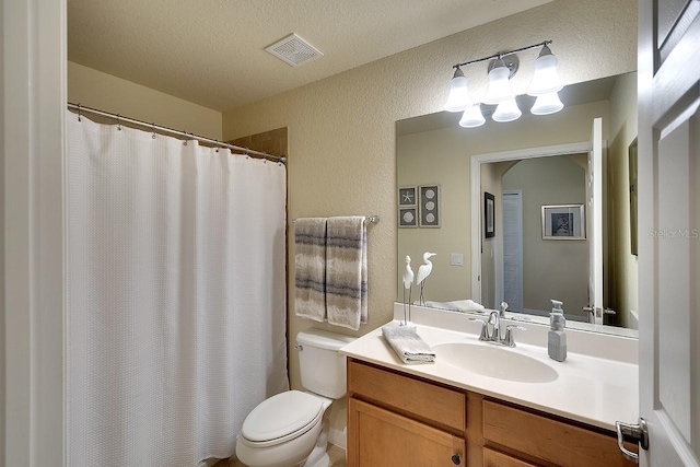 full bathroom with visible vents, a textured wall, toilet, a textured ceiling, and vanity