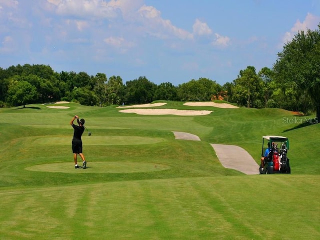 view of home's community with a yard and golf course view