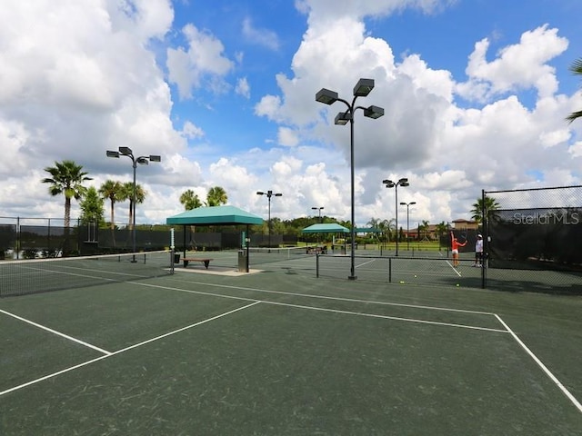 view of sport court featuring fence