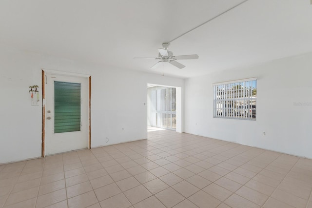 spare room featuring a wealth of natural light and ceiling fan