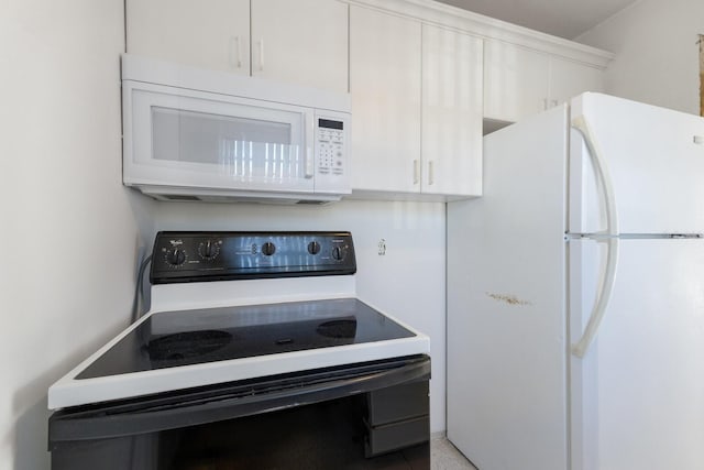 kitchen with light countertops, white appliances, and white cabinetry