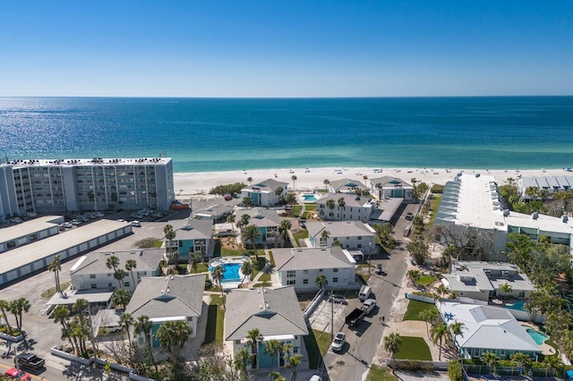 drone / aerial view featuring a beach view and a water view