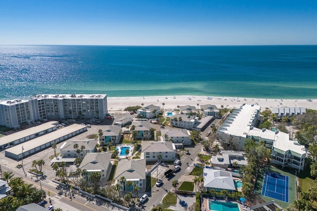 drone / aerial view with a water view and a beach view