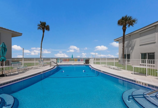 community pool featuring a patio area and fence