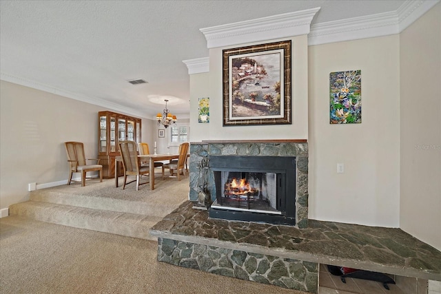 interior space featuring visible vents, an inviting chandelier, crown molding, a stone fireplace, and carpet floors