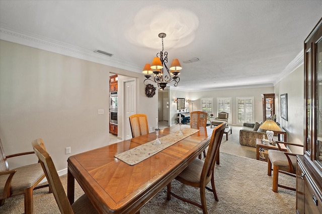 dining space featuring light colored carpet, visible vents, ornamental molding, a chandelier, and baseboards