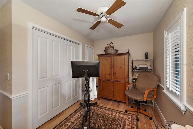 office with baseboards, ceiling fan, and light wood-style floors