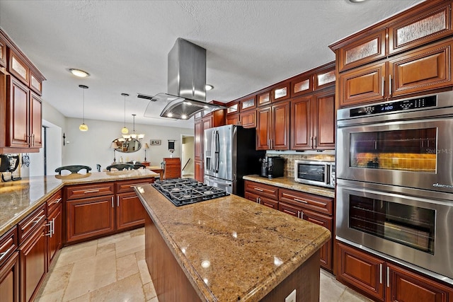 kitchen featuring island range hood, appliances with stainless steel finishes, decorative backsplash, a center island, and stone tile flooring