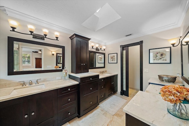 bathroom with two vanities, visible vents, a sink, and crown molding