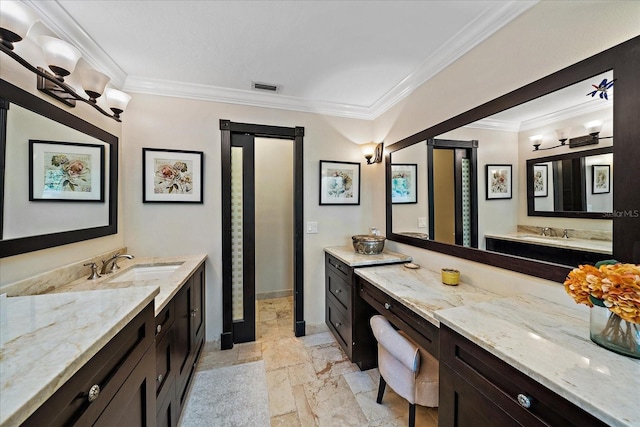 full bath featuring stone tile flooring, two vanities, visible vents, and crown molding