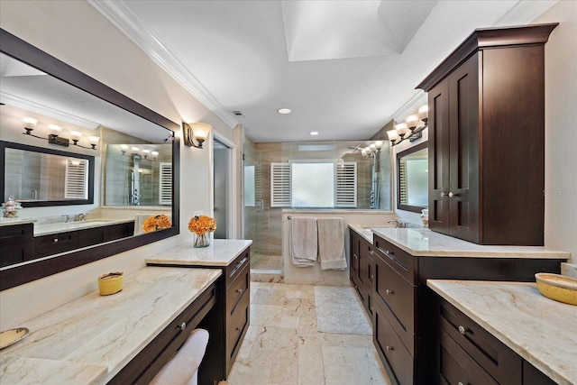 full bathroom featuring a sink, a shower stall, two vanities, and crown molding