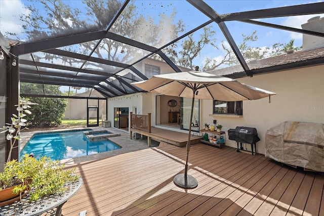 view of swimming pool with a lanai, a pool with connected hot tub, a deck, and area for grilling