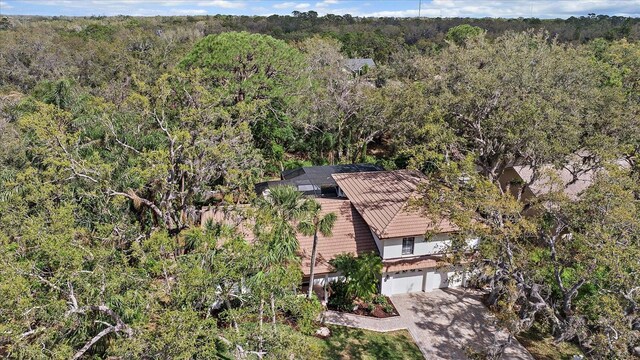 drone / aerial view featuring a view of trees