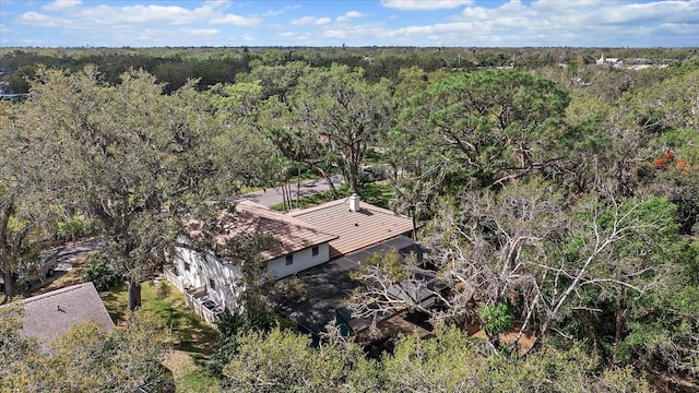 drone / aerial view featuring a wooded view