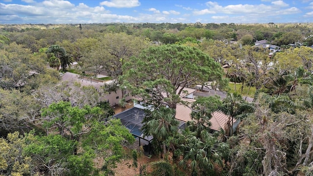 birds eye view of property with a view of trees