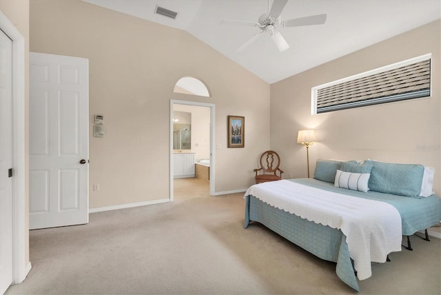 bedroom featuring ceiling fan, light colored carpet, visible vents, baseboards, and ensuite bath