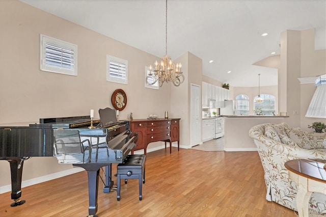 interior space featuring a notable chandelier, lofted ceiling, recessed lighting, light wood-type flooring, and baseboards