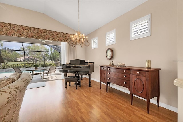 sitting room featuring vaulted ceiling, baseboards, a notable chandelier, and light wood-style floors